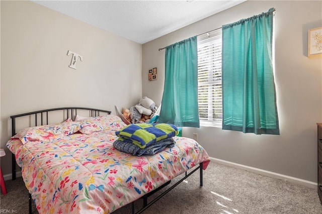 bedroom with carpet floors and multiple windows