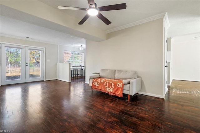 sitting room with ceiling fan, dark hardwood / wood-style flooring, crown molding, and french doors