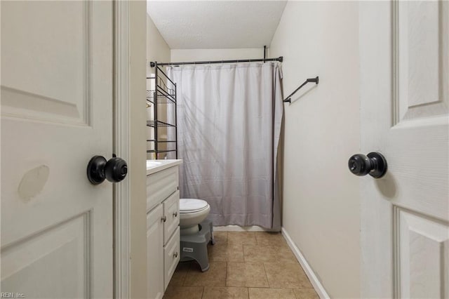 bathroom featuring vanity, tile patterned flooring, toilet, a textured ceiling, and curtained shower