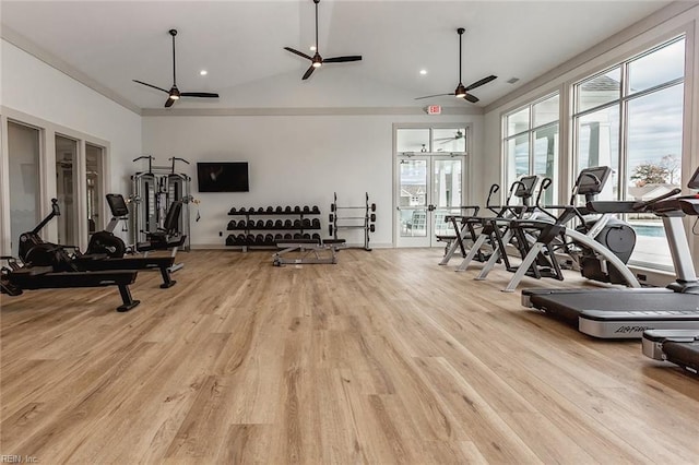 workout area with ceiling fan, vaulted ceiling, and light wood-type flooring