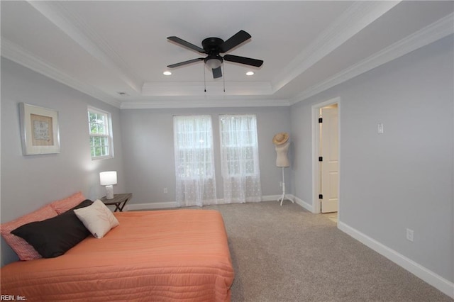 bedroom featuring a raised ceiling, ceiling fan, light carpet, and ornamental molding