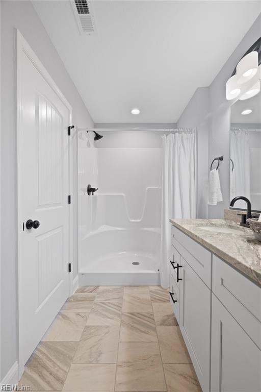 bathroom with vanity and walk in shower