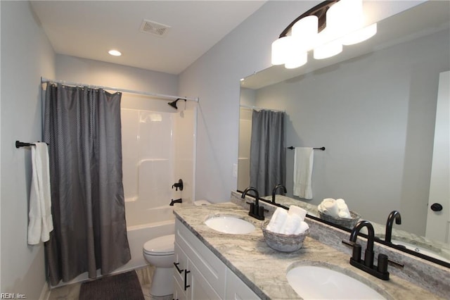 full bathroom with shower / bath combo with shower curtain, vanity, and toilet