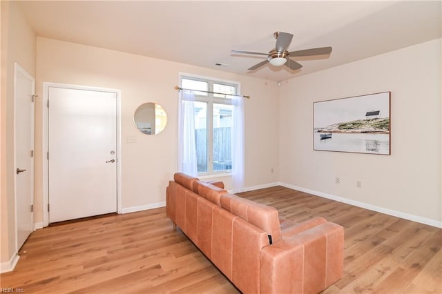 living room featuring ceiling fan and light wood-type flooring