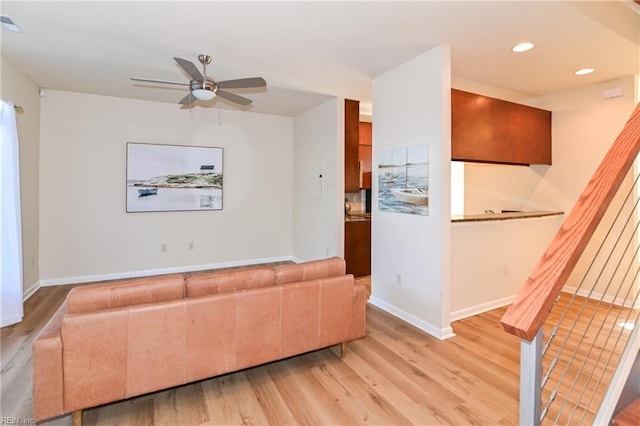 unfurnished living room featuring ceiling fan and light hardwood / wood-style floors