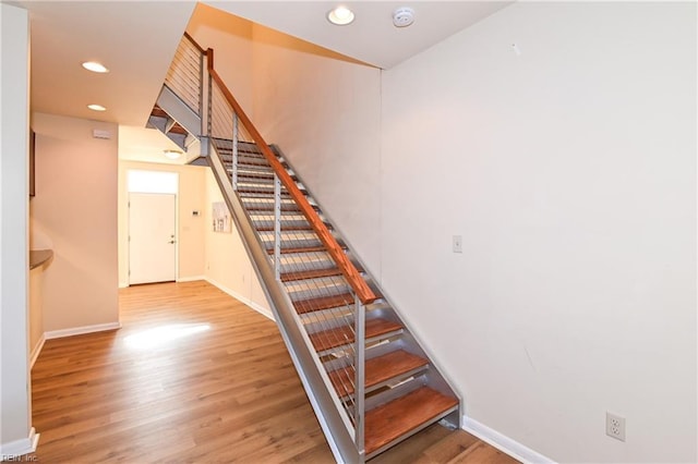 staircase featuring hardwood / wood-style floors