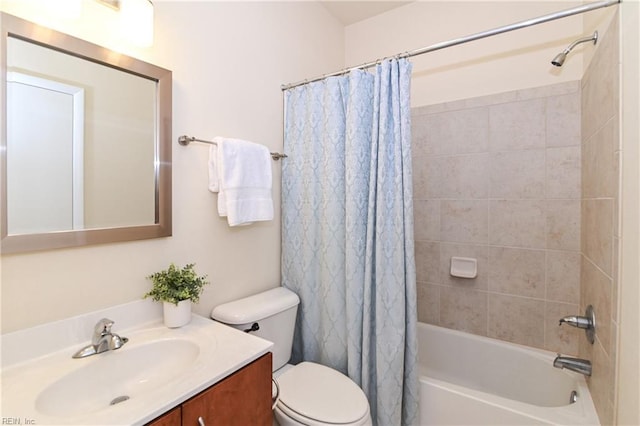 full bathroom featuring vanity, shower / tub combo, and toilet