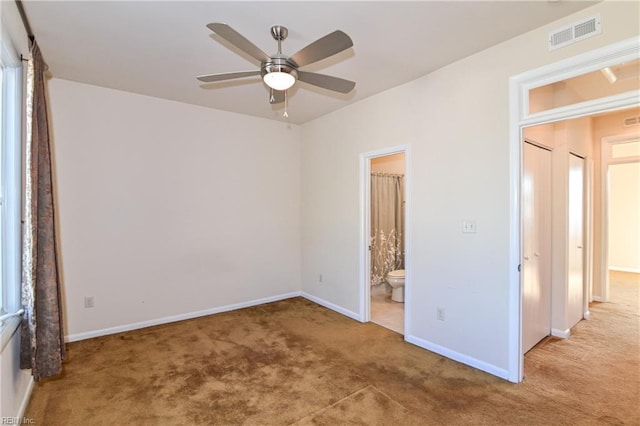 unfurnished bedroom with connected bathroom, ceiling fan, a closet, and light colored carpet