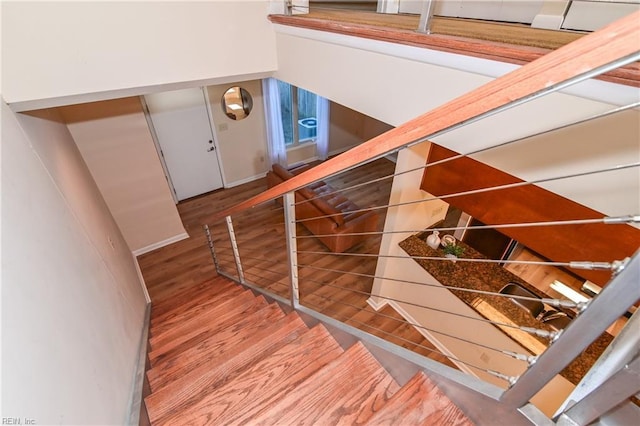 staircase with hardwood / wood-style flooring