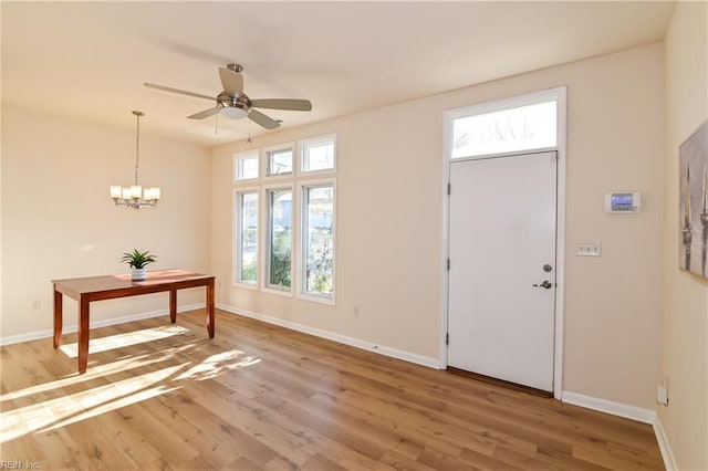 entryway featuring hardwood / wood-style floors and ceiling fan with notable chandelier