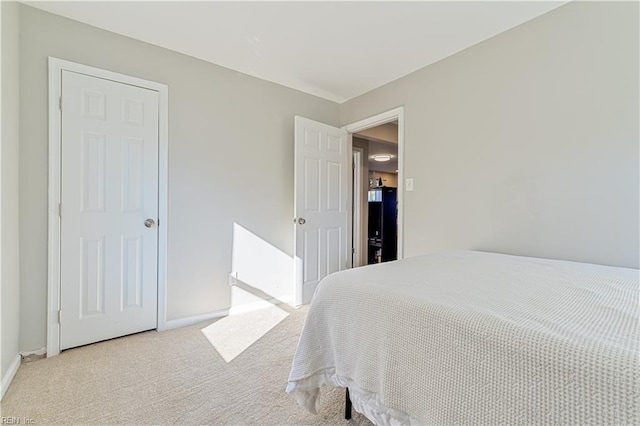 bedroom featuring light colored carpet