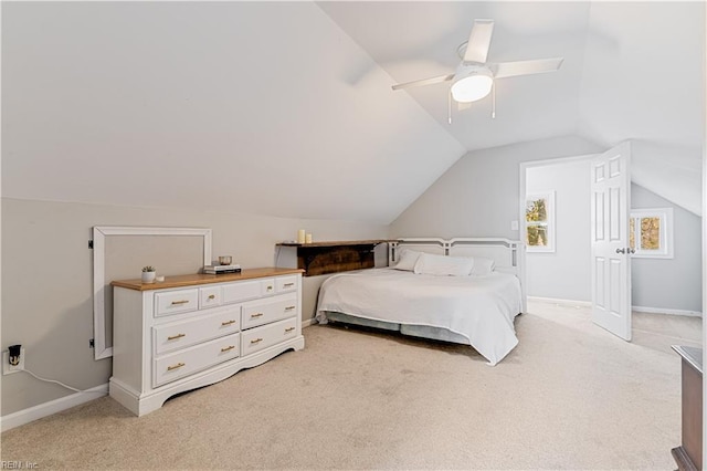 carpeted bedroom featuring ceiling fan and vaulted ceiling