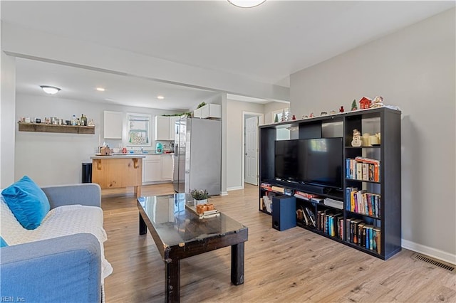 living room with light hardwood / wood-style flooring