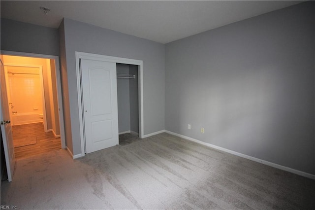 unfurnished bedroom with carpet and a closet