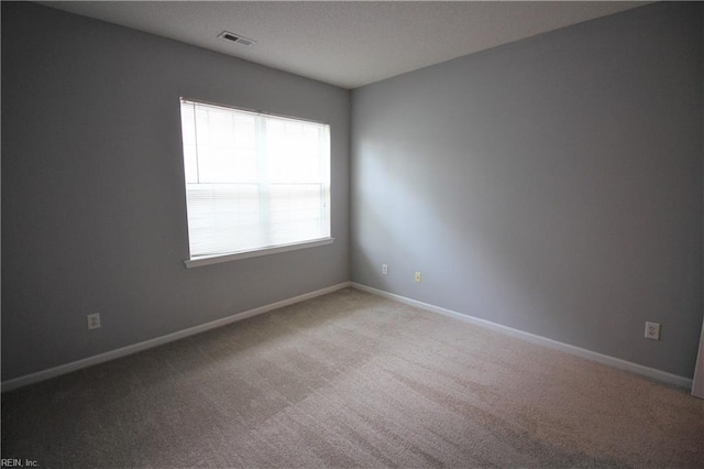 empty room with light colored carpet