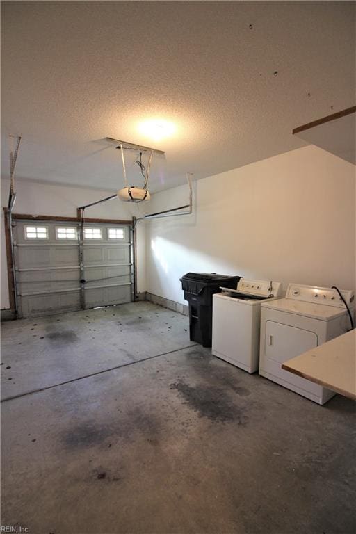 garage featuring a garage door opener and washing machine and clothes dryer