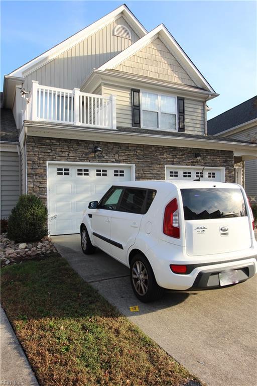 view of front facade featuring a balcony and a garage