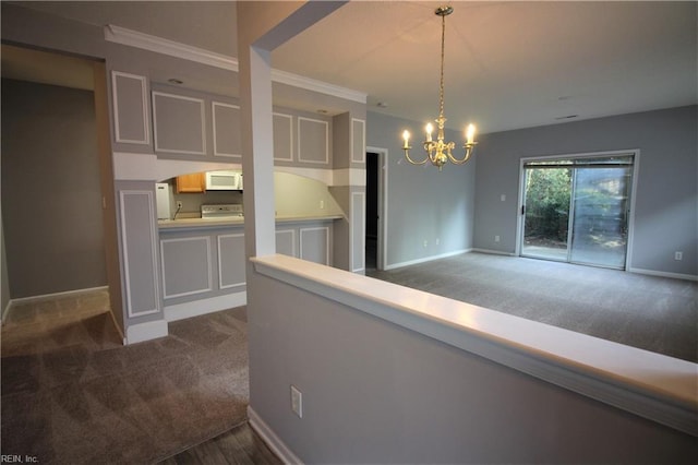 kitchen featuring a notable chandelier, crown molding, decorative light fixtures, white appliances, and dark carpet