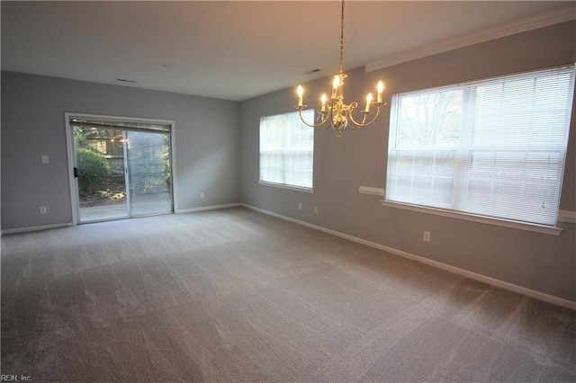 unfurnished room featuring carpet, ornamental molding, and an inviting chandelier