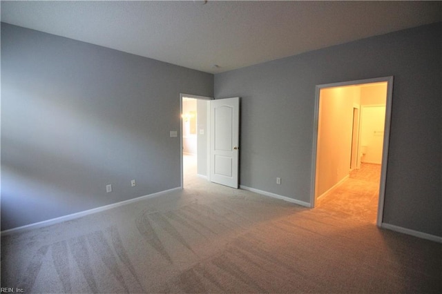 unfurnished bedroom featuring light carpet