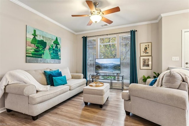 living room featuring hardwood / wood-style flooring, ceiling fan, and ornamental molding