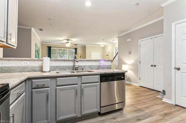 kitchen with light hardwood / wood-style floors, sink, stainless steel appliances, and tasteful backsplash