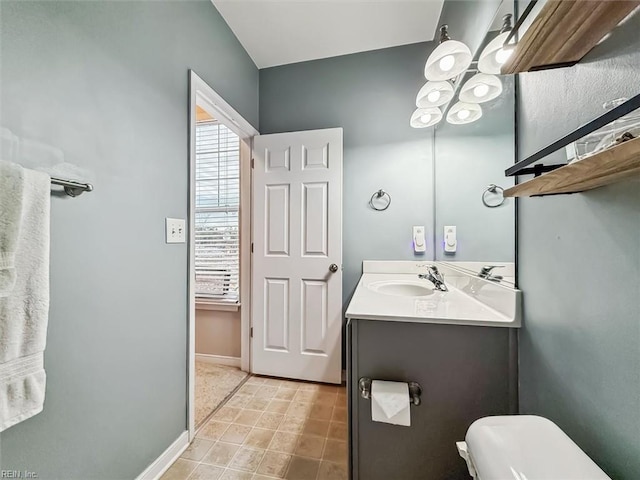 bathroom with vanity and toilet