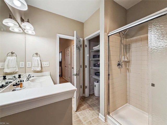 bathroom with a shower with door and vanity