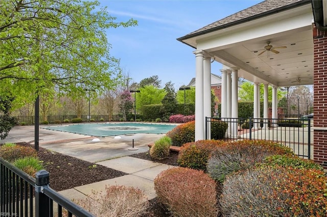 view of pool with a patio and ceiling fan