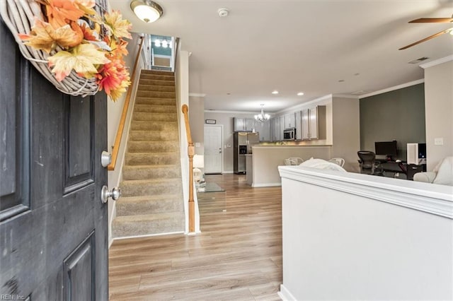 entrance foyer featuring crown molding, light hardwood / wood-style flooring, and ceiling fan