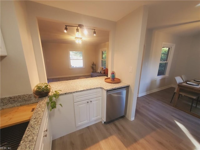 kitchen with dishwasher, plenty of natural light, and white cabinets