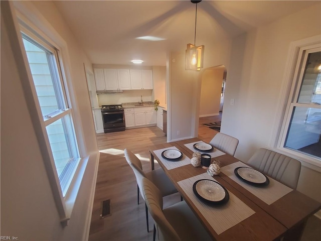 dining space featuring light hardwood / wood-style floors