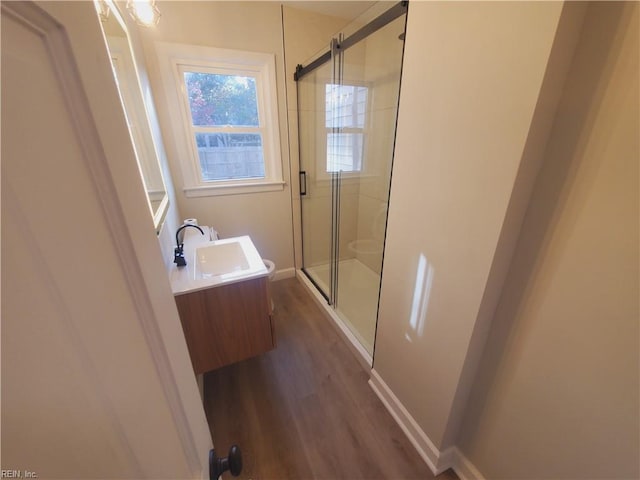 bathroom featuring hardwood / wood-style floors, vanity, and an enclosed shower