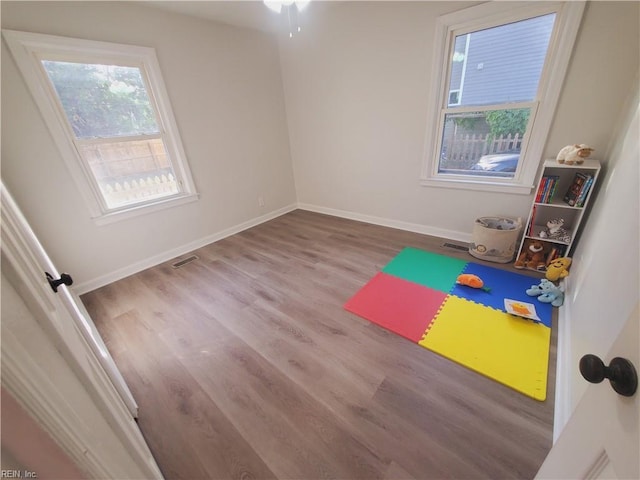 workout area with light hardwood / wood-style floors