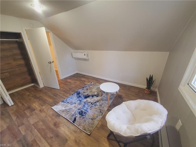 living area featuring dark hardwood / wood-style flooring, an AC wall unit, and lofted ceiling