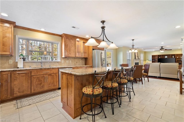 kitchen featuring backsplash, a center island, sink, and stainless steel appliances