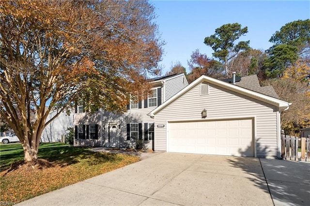 view of front of property featuring a front yard and a garage