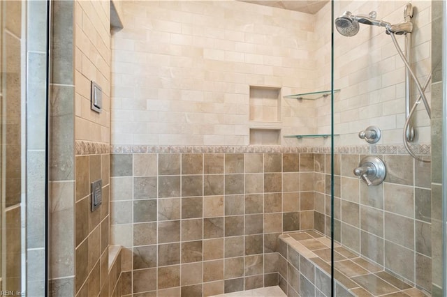 bathroom with tiled shower