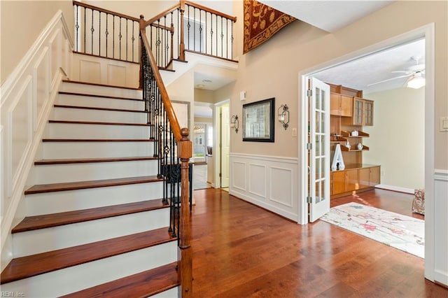 stairway featuring hardwood / wood-style flooring and ceiling fan