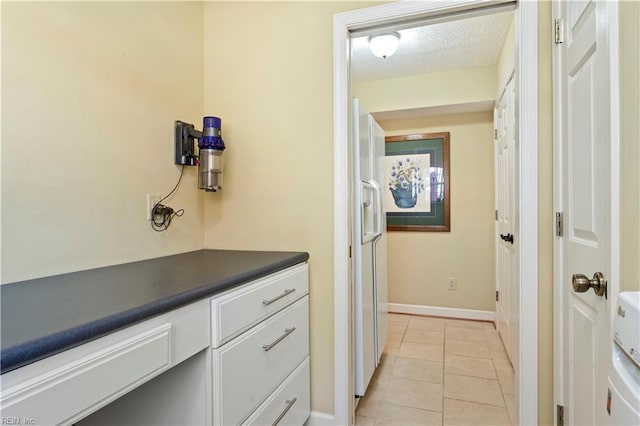 bathroom featuring tile patterned floors and a textured ceiling