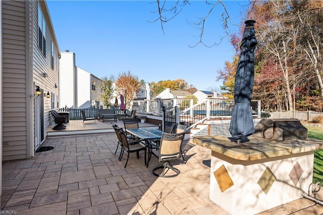 view of patio / terrace featuring exterior bar and a deck