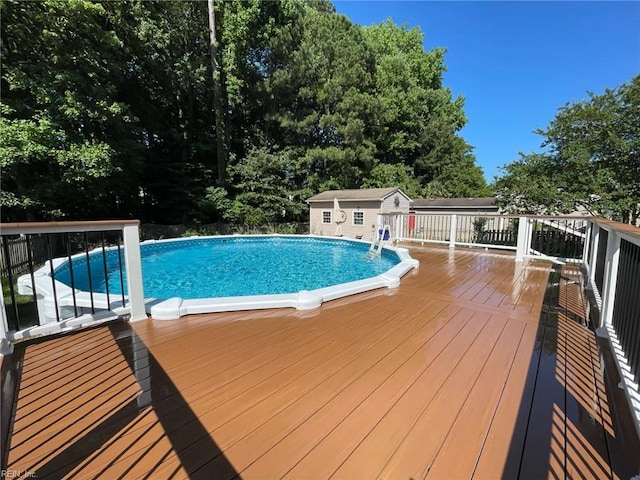 view of pool featuring an outdoor structure and a deck