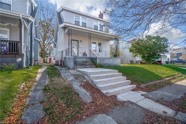 bungalow-style home with a porch and a front lawn