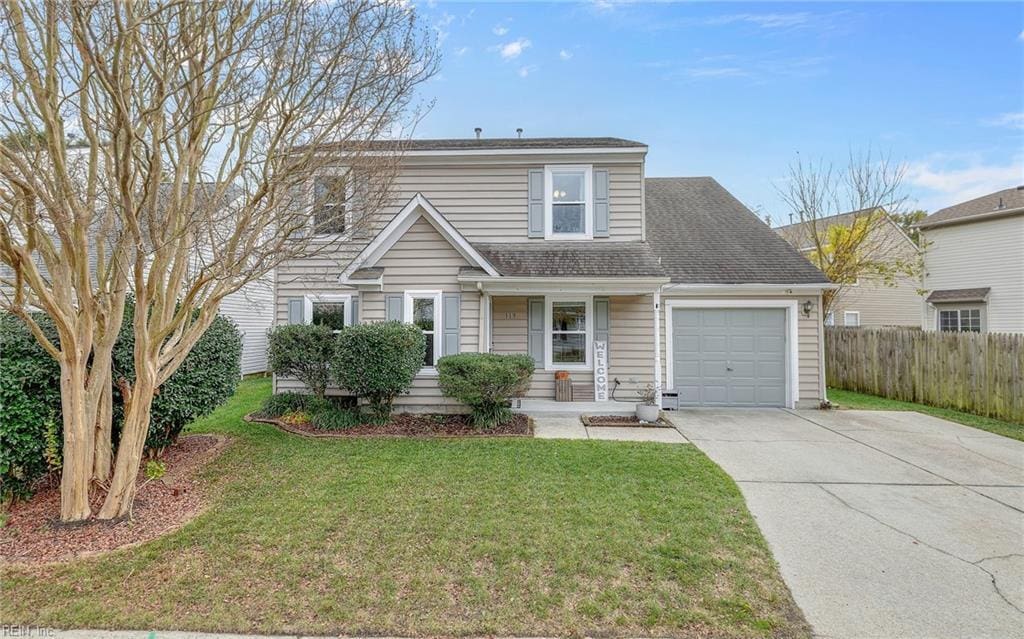 front facade featuring a front yard and a garage