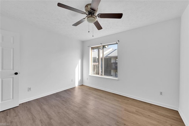 spare room with ceiling fan, light hardwood / wood-style floors, and a textured ceiling