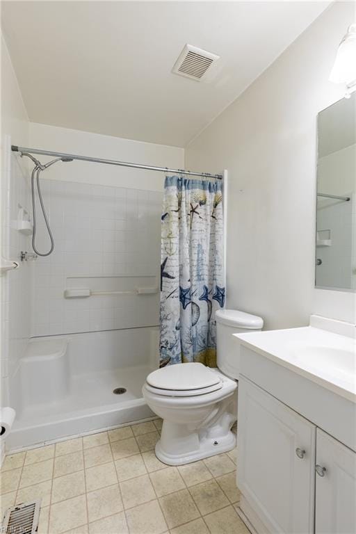 bathroom with tile patterned flooring, vanity, toilet, and curtained shower