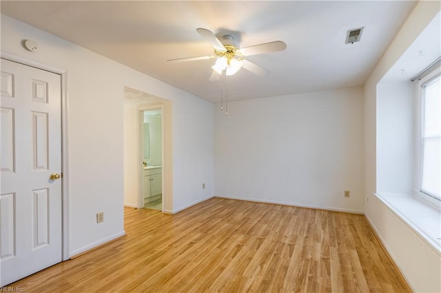 empty room featuring ceiling fan and light hardwood / wood-style flooring