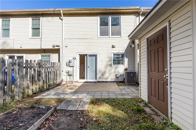 rear view of house featuring central AC and a patio area