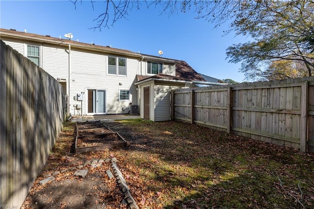 rear view of house featuring central AC