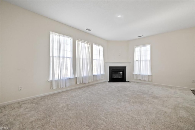 unfurnished living room with light colored carpet